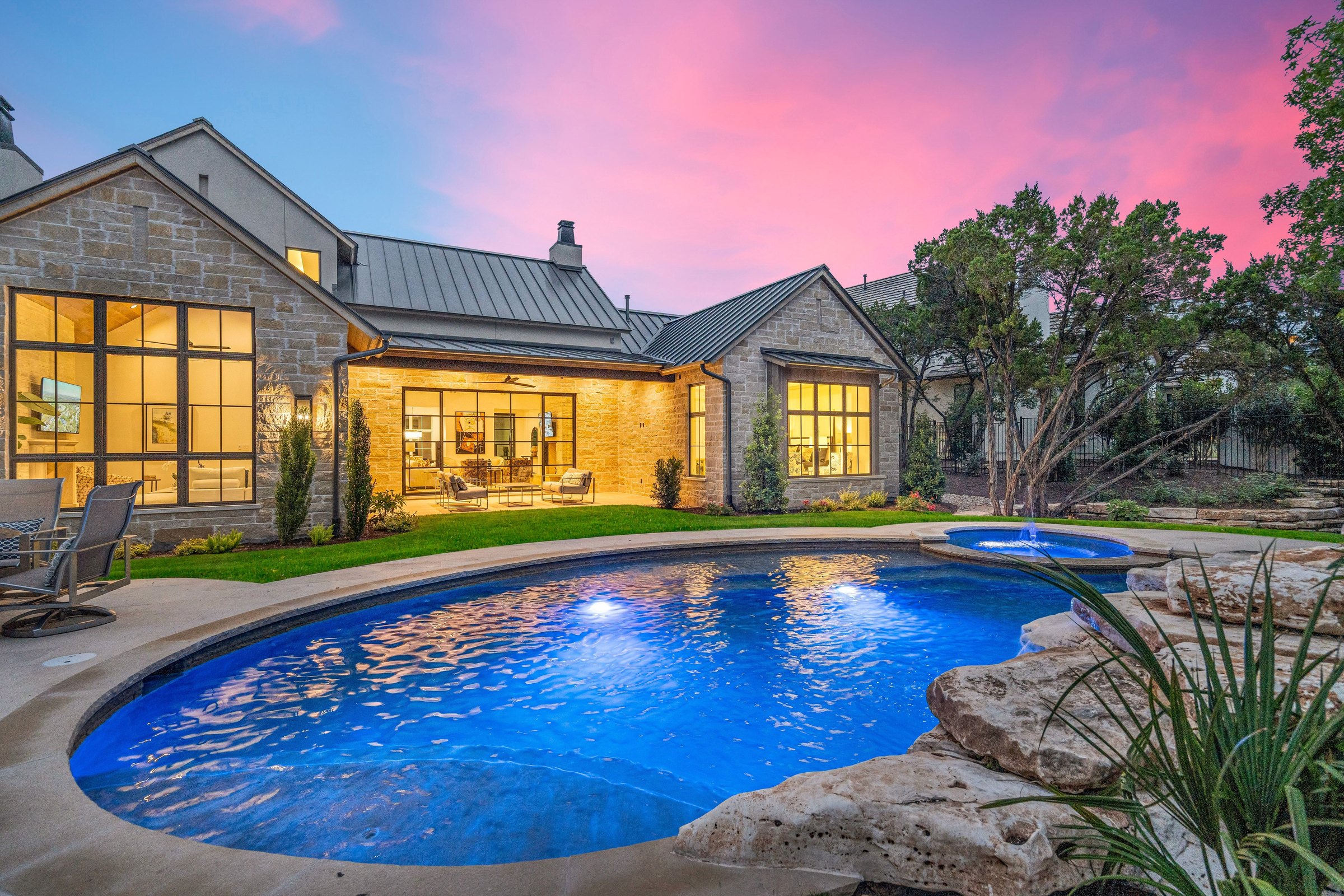 Pool and rear elevation at 4300 Amarra Drive at twilight